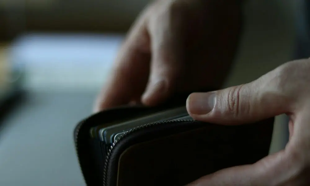 a person holding a wallet in their hand