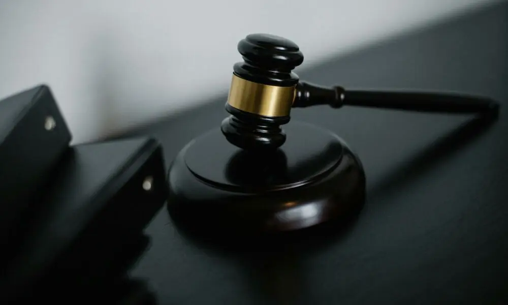 Close-up of a wooden gavel on a desk, symbolizing justice and legal authority.
