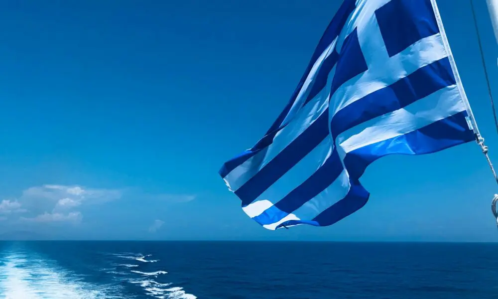 blue and white striped flag on the sea during daytime