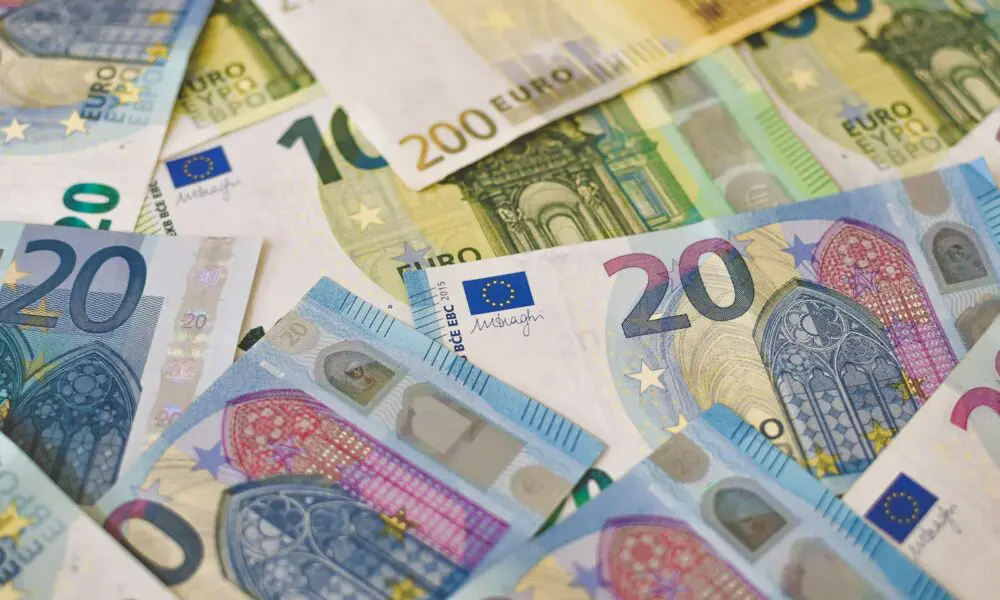 20 euro bill on white and blue textile