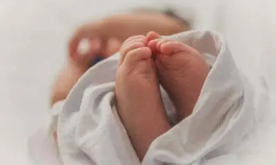 baby covered with white blanket