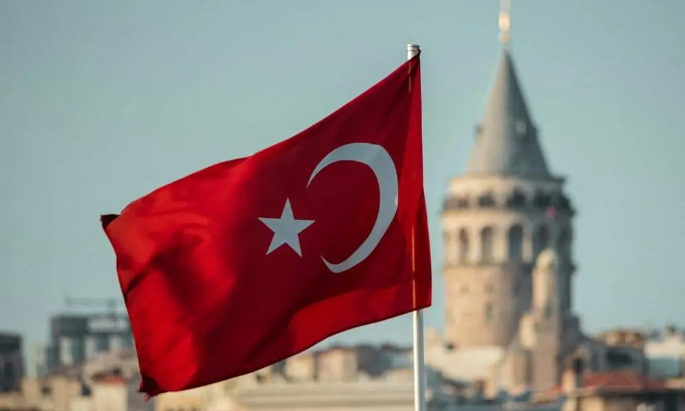 a turkey flag flying in front of a building