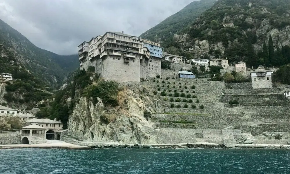 white and brown concrete building near body of water during daytime