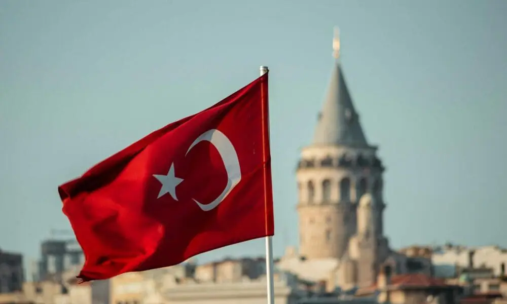 a turkey flag flying in front of a city