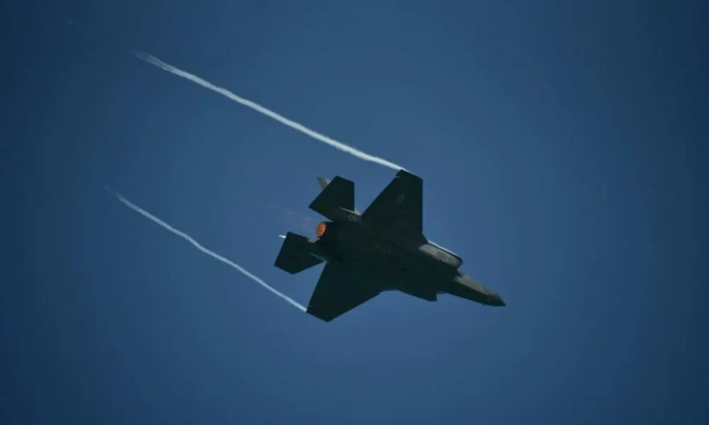 black jet plane in mid air under blue sky during daytime