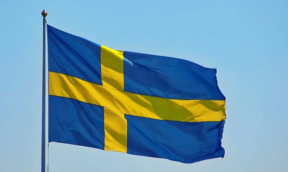 a blue and yellow flag flying in the sky