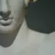 white concrete statue of man