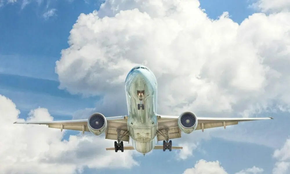 gray and white airplane on flight near clear blue sky