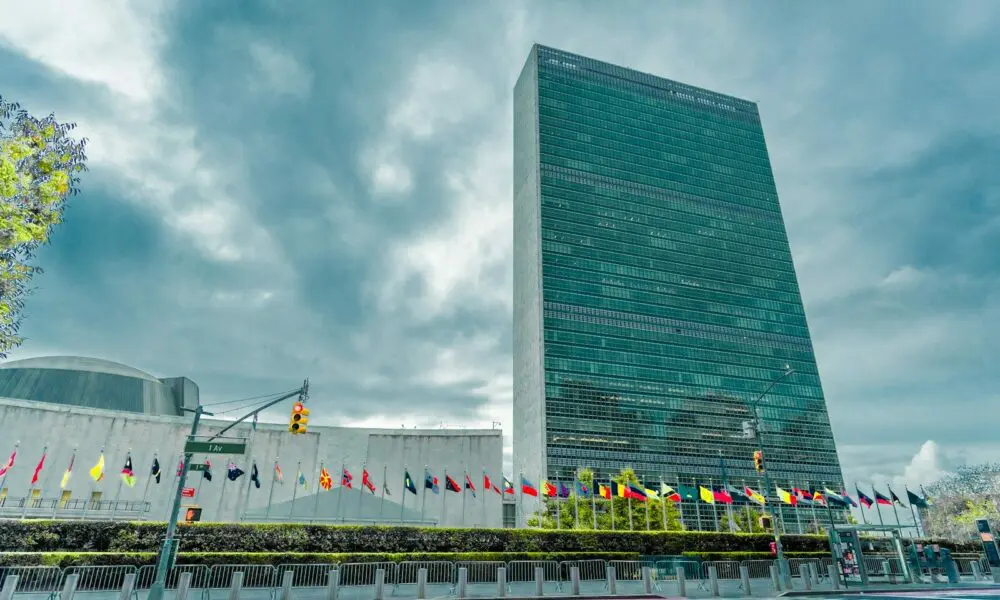 A very tall building sitting next to a body of water
