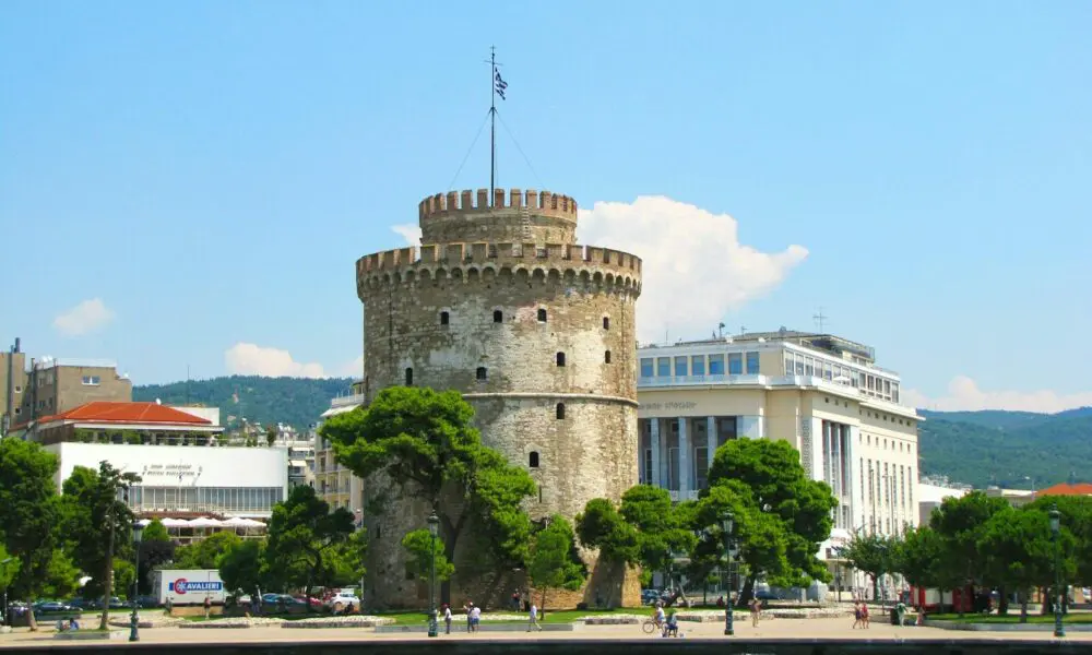 a large castle sitting on top of a lush green hillside