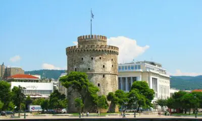 a large castle sitting on top of a lush green hillside