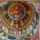 A painting of jesus on the ceiling of a church