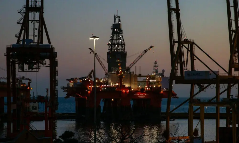 The West Bollsta semi-submersible drilling rig docked in a harbor at low light