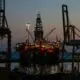 The West Bollsta semi-submersible drilling rig docked in a harbor at low light