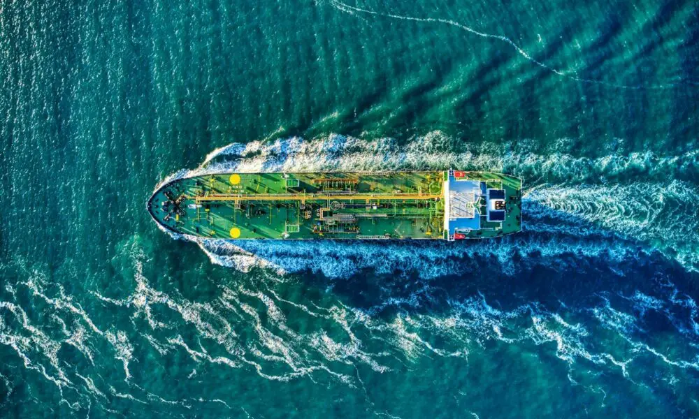aerial view of white and yellow boat on body of water during daytime