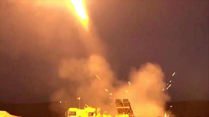A multi-rocket launcher fires in an unknown location