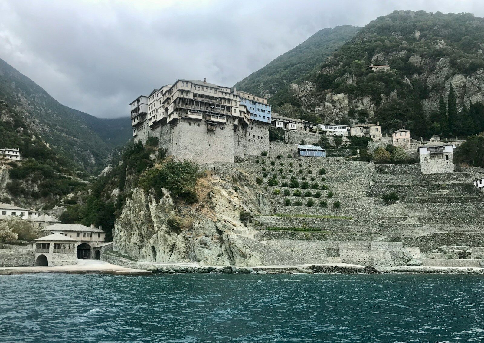 white and brown concrete building near body of water during daytime