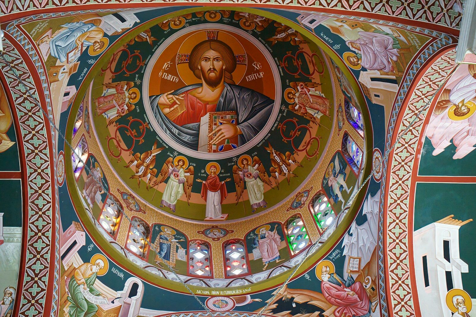 A painting of jesus on the ceiling of a church