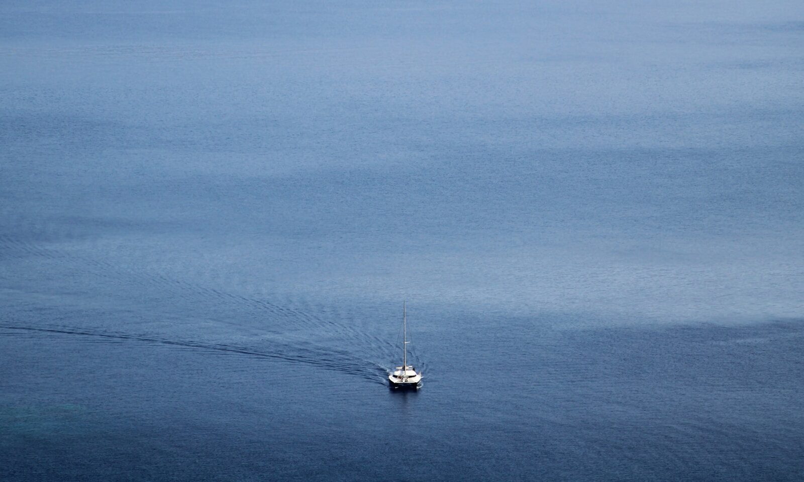 white boat on blue sea under blue sky during daytime
